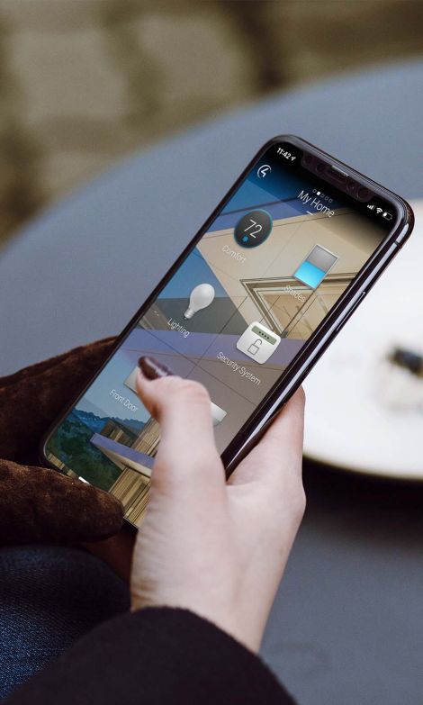 A smartphone screen showing the Control4 smart home automation interface with icons for various home functions such as lighting, security, and climate control.