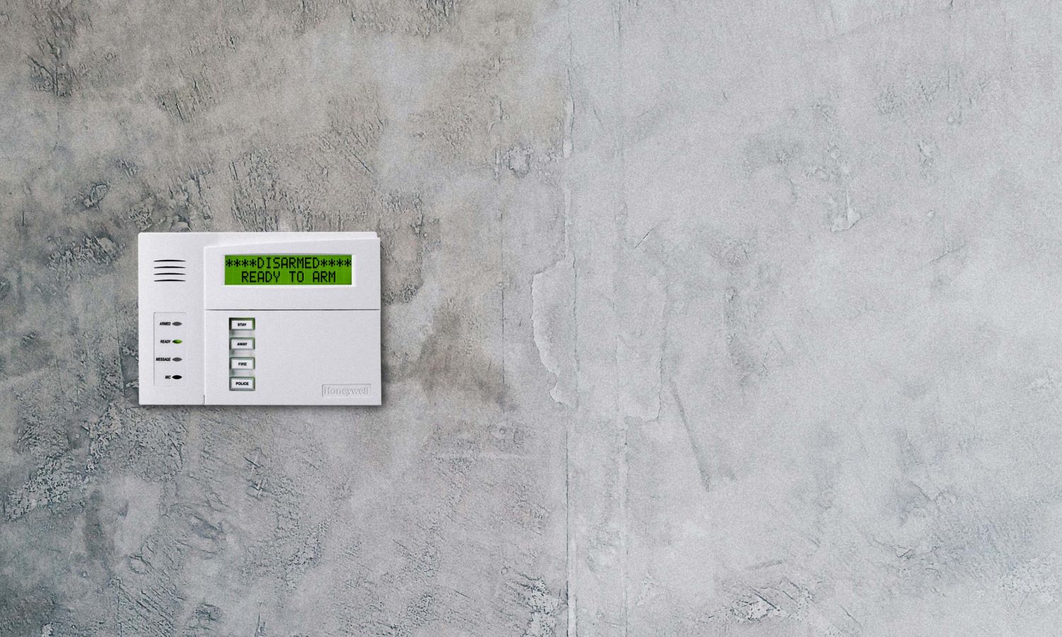 burglar alarm on a grey cement wall