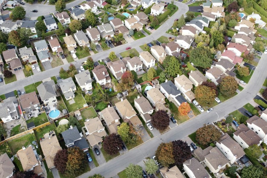 Aerial view of a suburban neighborhood with tree-lined streets.