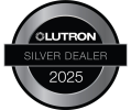 A circular silver badge with the LUTRON logo at the top, a black band reading “SILVER DEALER” across the middle, and “2024” below, all set against a black background.