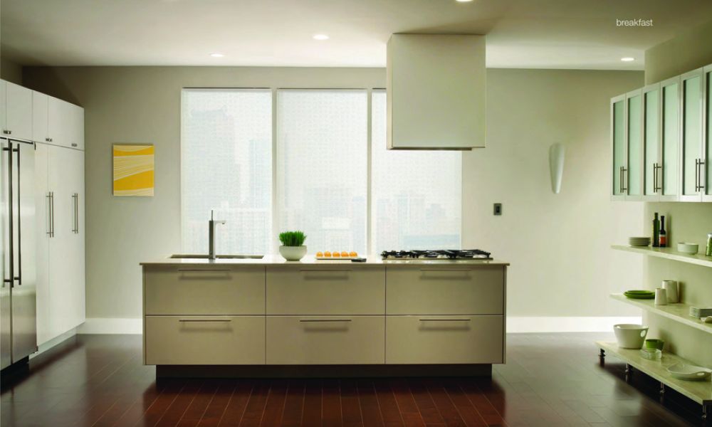 A kitchen featuring Lutron lights and motorized shades.