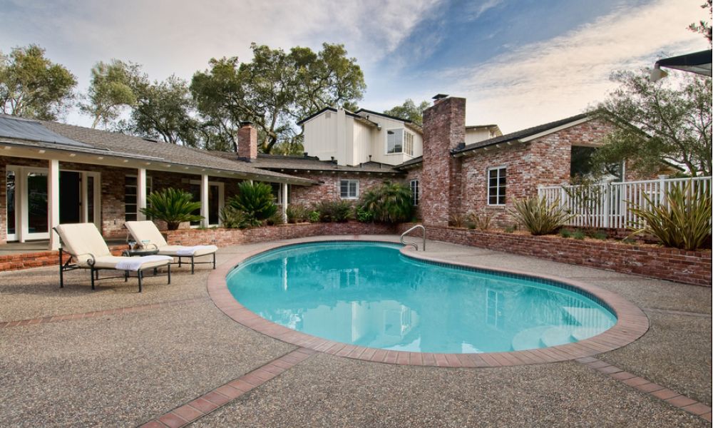 A home with a pool in the backyard.